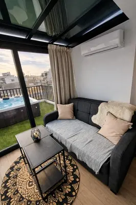 a living room with a couch and a table at Athens Center Apartment with Private Jacuzzi in Athens
