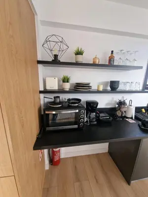 a kitchen with a black counter with a toaster oven at Athens Center Apartment with Private Jacuzzi in Athens