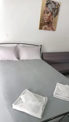 a bed with two white towels on top of it at Афіни Лофт in Piraeus