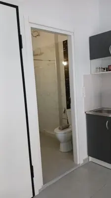 a bathroom with a toilet and a glass doorway at Афіни Лофт in Piraeus