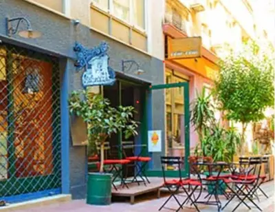 a group of tables and chairs outside of a building at Athenian blue in Athens