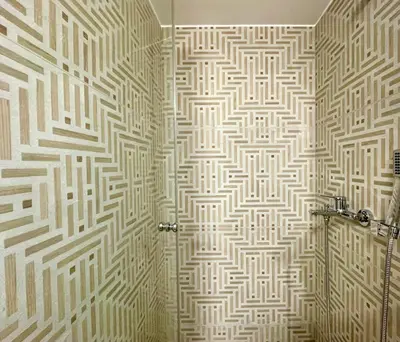 a bathroom with a shower with a patterned wall at Athenian blue in Athens