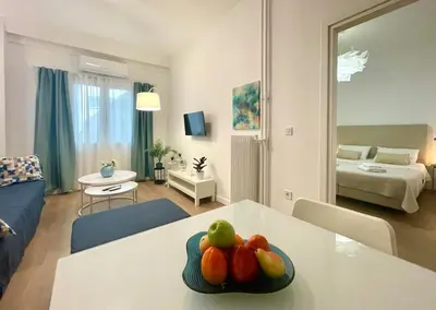 a living room with a table with fruit on it at Athenian blue in Athens