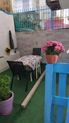 a patio with a table and chairs and flowers at Kipsely room in Athens