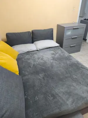 a large bed in a room with a dresser at Kipsely room in Athens