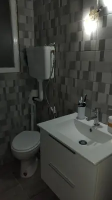 a bathroom with a toilet and a sink at Kipsely room in Athens