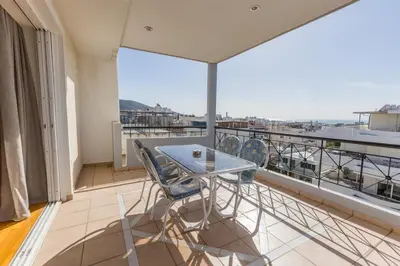 a balcony with a table and chairs and a view at Raise Glyfada Sky Residence in Athens