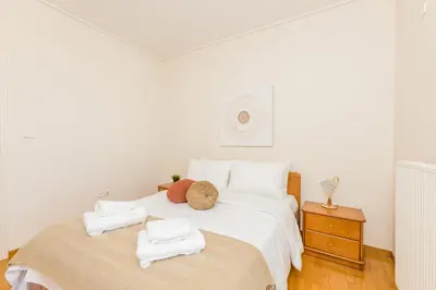 a bedroom with a white bed with towels on it at Raise Glyfada Sky Residence in Athens