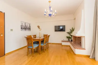a dining room with a table and chairs at Raise Glyfada Sky Residence in Athens