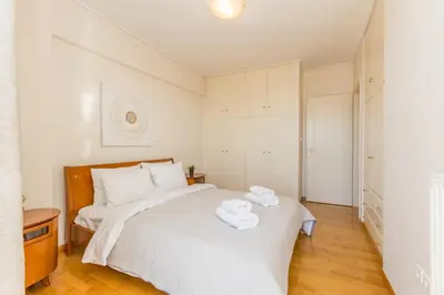 a bedroom with a bed with two towels on it at Raise Glyfada Sky Residence in Athens