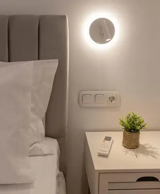 a bedroom with a bed and a table with a plant on it at Athens Vibes in Kipseli in Athens
