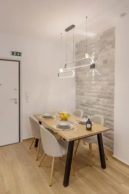 a dining room with a wooden table and chairs at Athens Vibes in Kipseli in Athens
