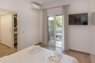 a white room with a bed with towels on it at Athens Vibes in Kipseli in Athens