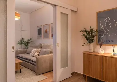 a living room with a couch and a table at Stylish Modern apartment, 10' from the center! in Athens