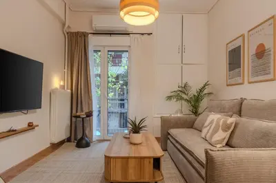 a living room with a couch and a table at Stylish Modern apartment, 10' from the center! in Athens