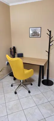 a yellow chair sitting in front of a desk at Dramas17 - PS5 in Piraeus