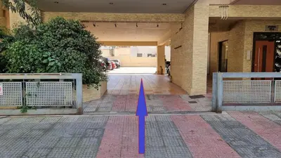 a building with a blue arrow pointing into a hallway at Dramas17 - PS5 in Piraeus