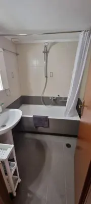 a bathroom with a shower and a sink and a tub at Dramas17 - PS5 in Piraeus
