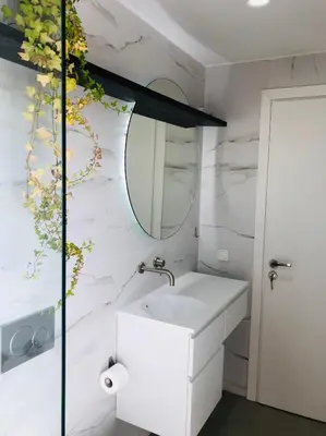 a bathroom with a white sink and a mirror at Glyfada Amazing Suite with sea view & jacuzzi in Athens