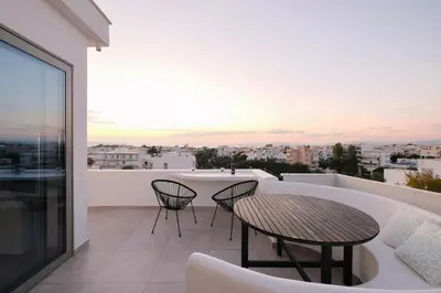 a balcony with a table and chairs and a view at Glyfada Amazing Suite with sea view & jacuzzi in Athens