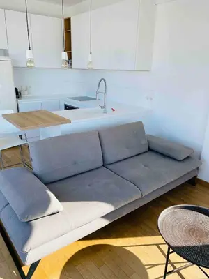 a living room with a couch and a kitchen at Glyfada Amazing Suite with sea view & jacuzzi in Athens