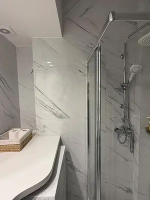 a bathroom with a shower and a sink at Estía Cozy City Apartment in Athens