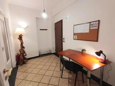 a room with a desk and a table with a lamp at Tranquil Athenian Home - City Center in Athens