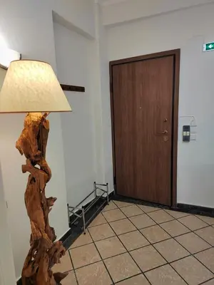 a lamp sitting in a room with a wooden floor at Tranquil Athenian Home - City Center in Athens