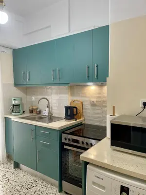 a kitchen with blue cabinets and a sink at Tranquil Athenian Home - City Center in Athens