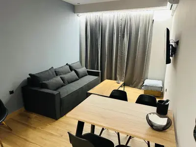a living room with a couch and a table at Brown Balcony Suite No 1, Piraeus Port in Piraeus