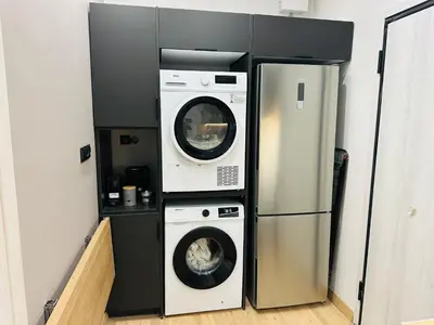 a kitchen with two washing machines and a refrigerator at Brown Balcony Suite No 1, Piraeus Port in Piraeus