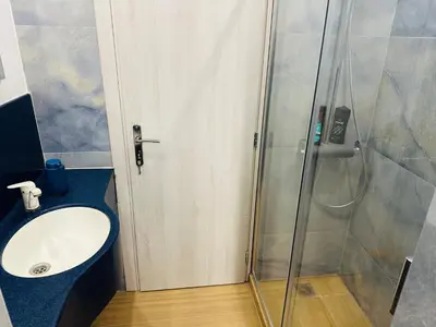a bathroom with a sink and a shower at Brown Balcony Suite No 1, Piraeus Port in Piraeus