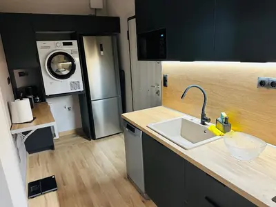 a kitchen with a sink and a washing machine at Brown Balcony Suite No 1, Piraeus Port in Piraeus