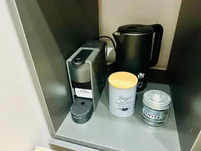 a coffee maker and a coffeemaker sitting on a shelf at Brown Balcony Suite No 1, Piraeus Port in Piraeus