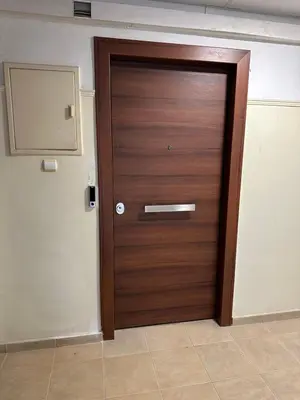 a wooden door in a room with a wall at Brown Balcony Suite No 1, Piraeus Port in Piraeus