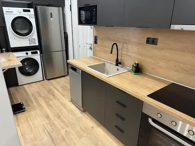 a kitchen with a sink and a washer and dryer at Brown Balcony Suite No 1, Piraeus Port in Piraeus