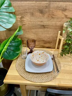 a table with a bowl and a plate with a glass at Athenee Riviera in Athens