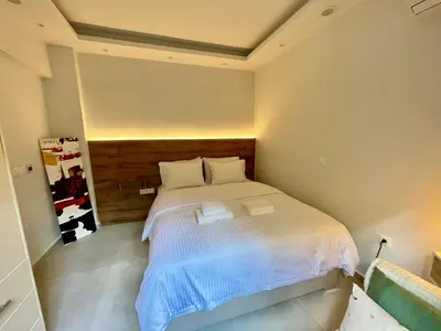 a bedroom with a white bed in a room at Athenee Riviera in Athens