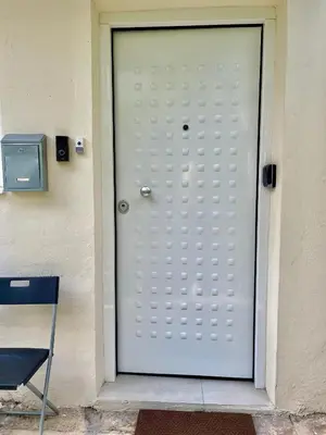 a white door on the side of a building at Athenee Riviera in Athens