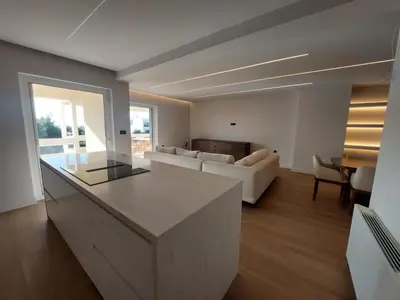 a living room with a couch and a table at Voula Seaview Residence in Athens