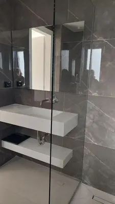 a bathroom with two sinks and a mirror at Voula Seaview Residence in Athens