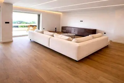 a large white couch in a living room with a large window at Voula Seaview Residence in Athens