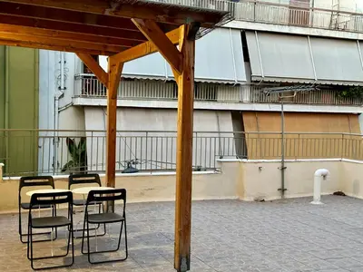 a group of chairs and a table on a patio at Aria Home - Modern & Classic with Terrace by TT in Athens