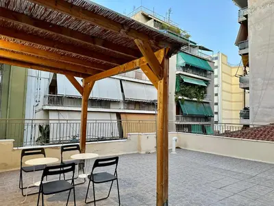 a group of tables and chairs on a patio at Aria Home - Modern & Classic with Terrace by TT in Athens