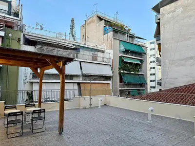 a balcony with two chairs and a building at Aria Home - Modern & Classic with Terrace by TT in Athens