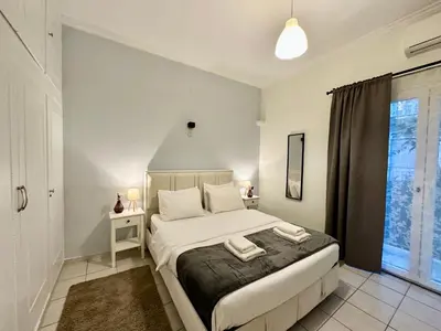 a bedroom with a bed with two towels on it at Aria Home - Modern & Classic with Terrace by TT in Athens