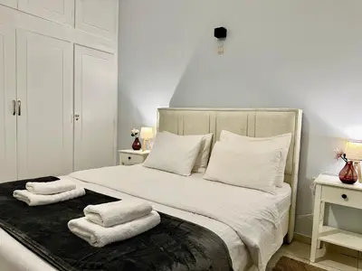 a bedroom with a bed with towels on it at Aria Home - Modern & Classic with Terrace by TT in Athens