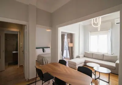 a living room with a couch and a table at Athens Imperial Suite 1 in Athens