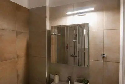 a bathroom with a shower with a sink and a mirror at Athens Imperial Suite 1 in Athens