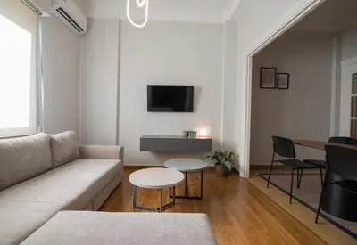 a living room with a couch and a table at Athens Imperial Suite 1 in Athens